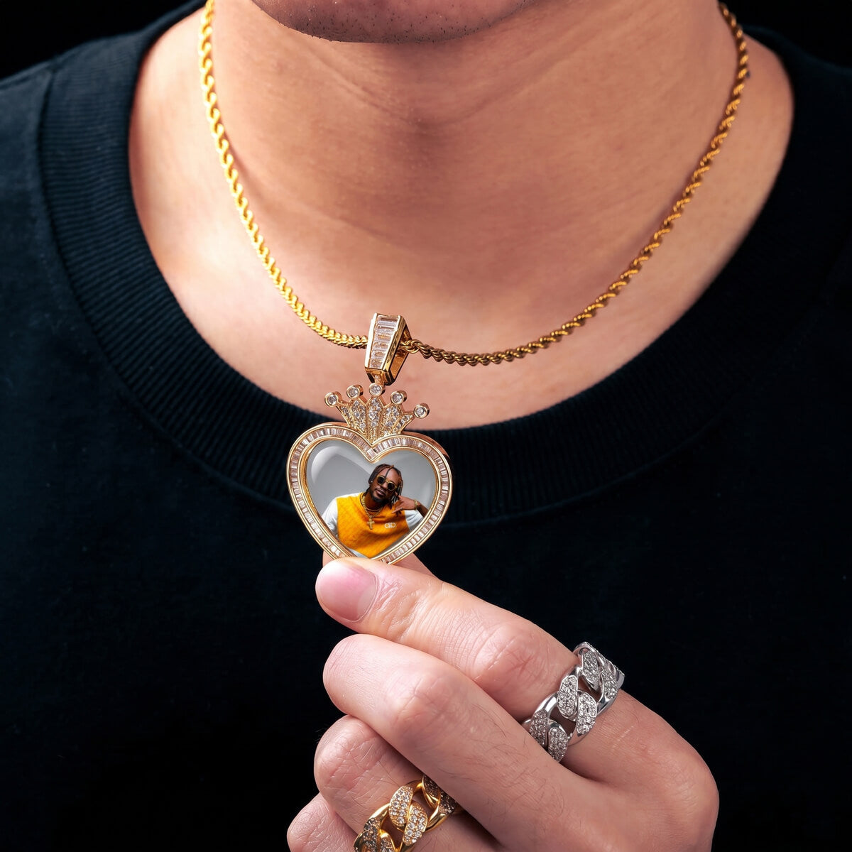 person waring a crown heart picture necklace