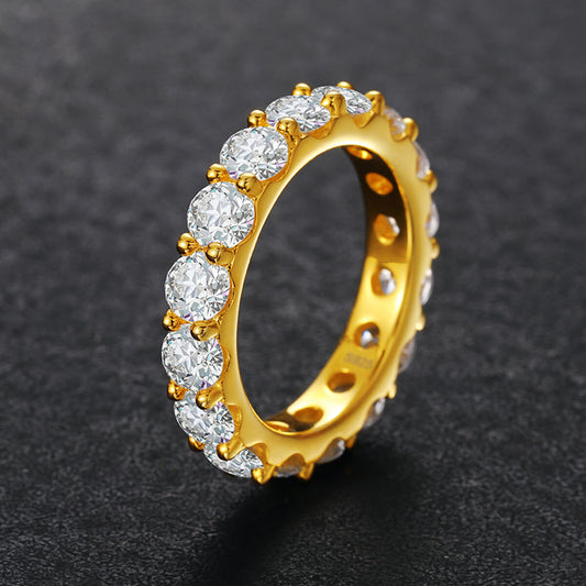 Gold ring with diamonds on a dark background