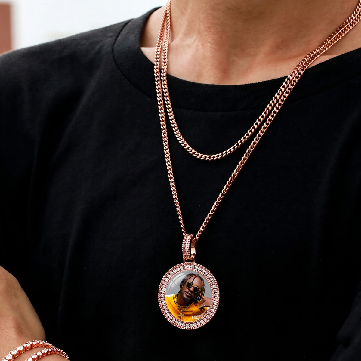 Person wearing iced out 3D picture pendant necklace