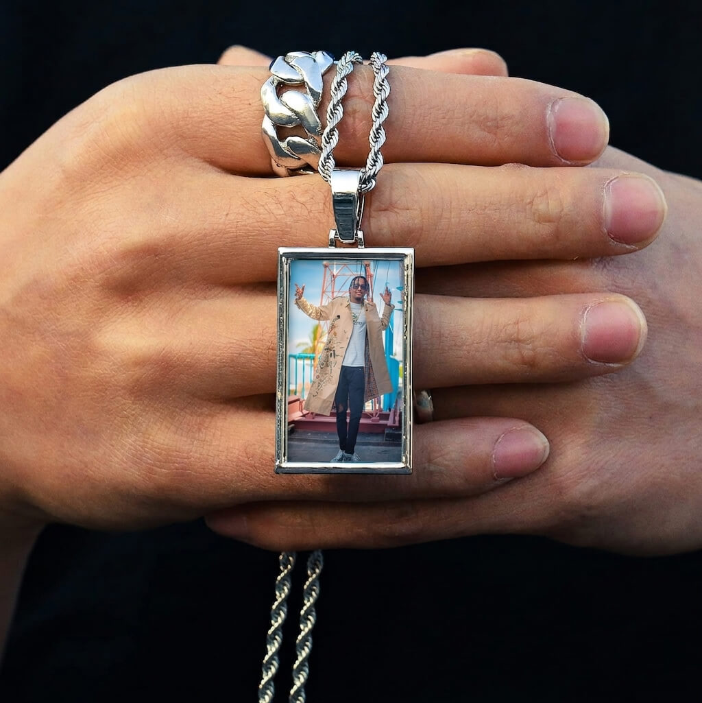 Hand holding a  custom iced-out picture pendant Close View