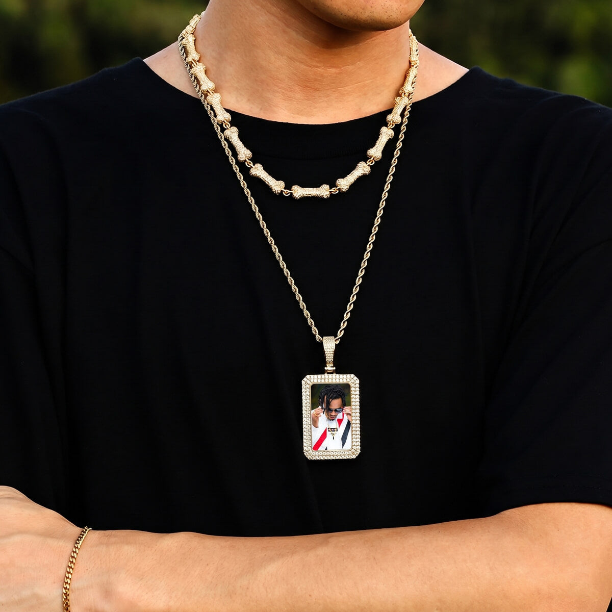 Person wearing iced out square picture chain