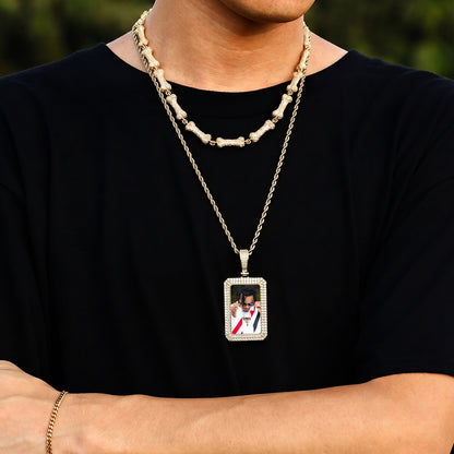Person wearing iced out square picture chain