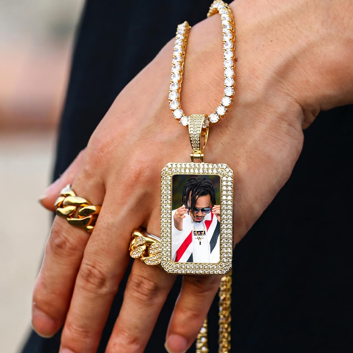 Hand wearing iced out square chain necklace