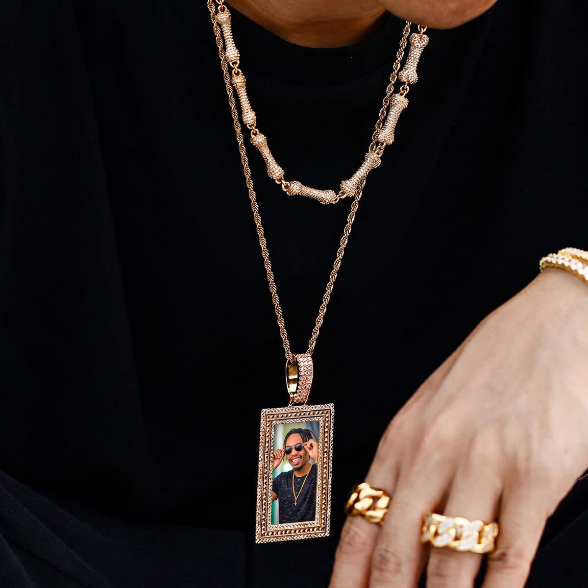 Person wearing rectangle memory picture necklace