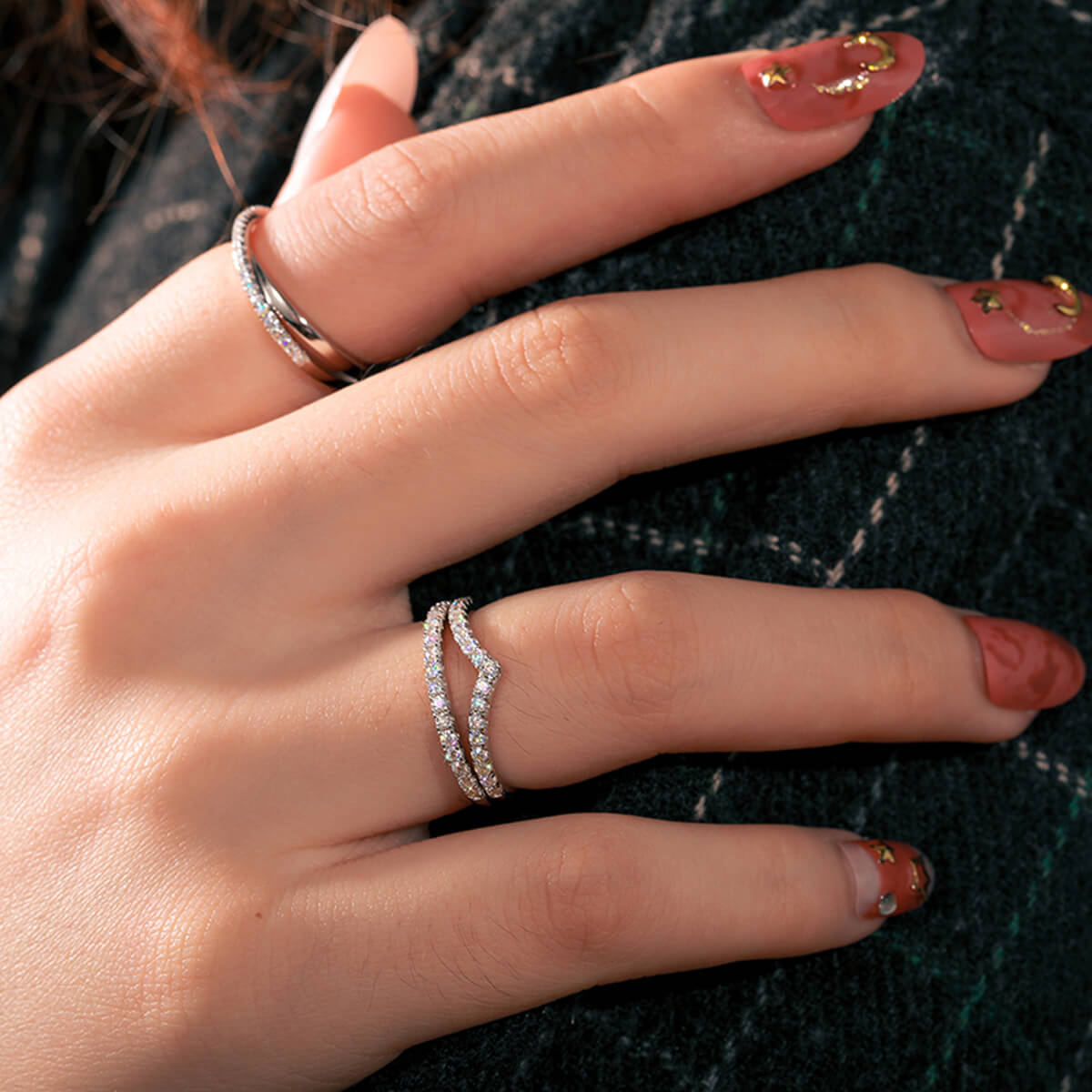 Woman wearing Micro Pavé Half Eternity Wedding Ring in silver with sparkling white stones and a delicate stackable design.