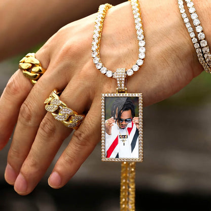 Person holding rectangle iced out picture pendant necklace