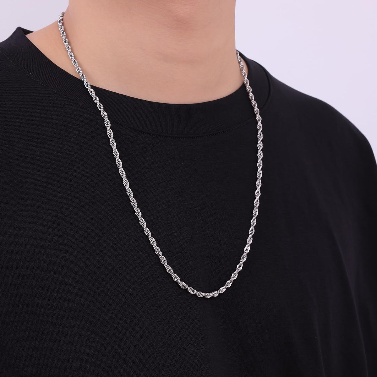 person wearing silver stainless steel rope chain necklace